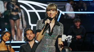 Taylor Swift accepts an award on stage at the 2022 MTV Europe Music Awards.